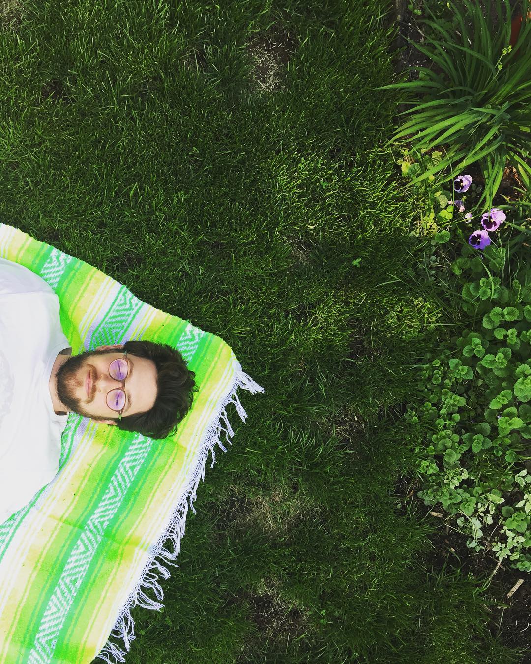 Jordan lying on a blanket in the grass